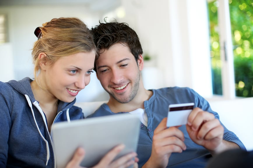 Happy young couple doing shopping on internet