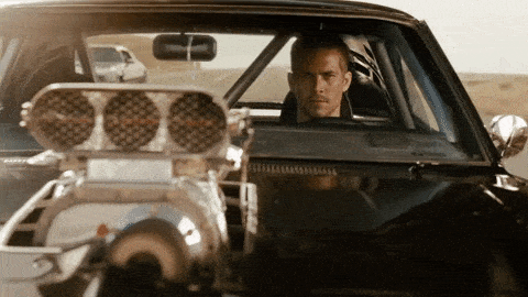 Paul Walker sits in a sports car. Rebuy Smart Cart is the sports car of ecommerce shopping carts.