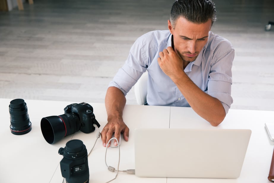 Portrait of an entrepreneur using Rebuy, Shopify on his laptop