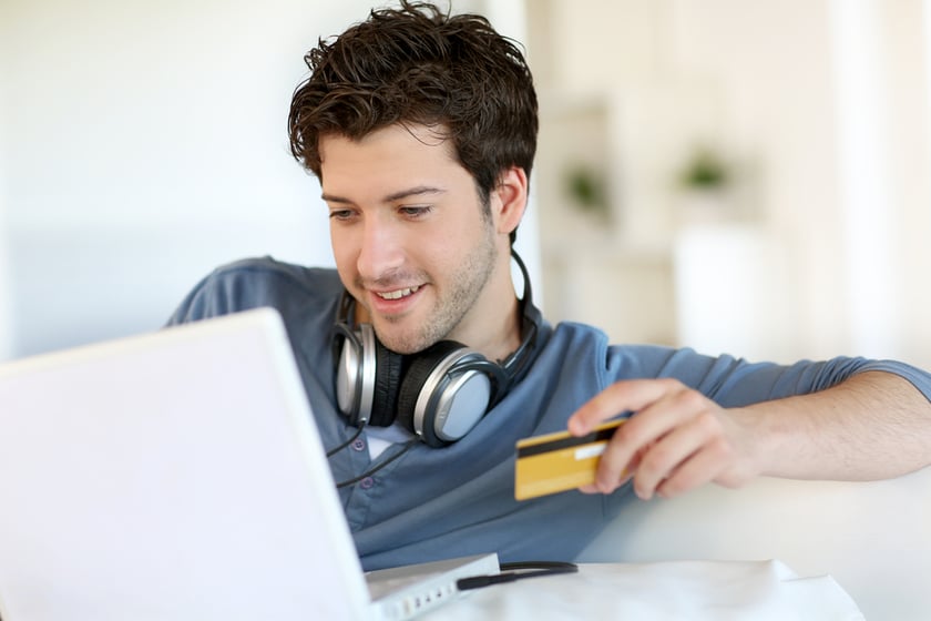 Young man buying music on internet with tablet-1